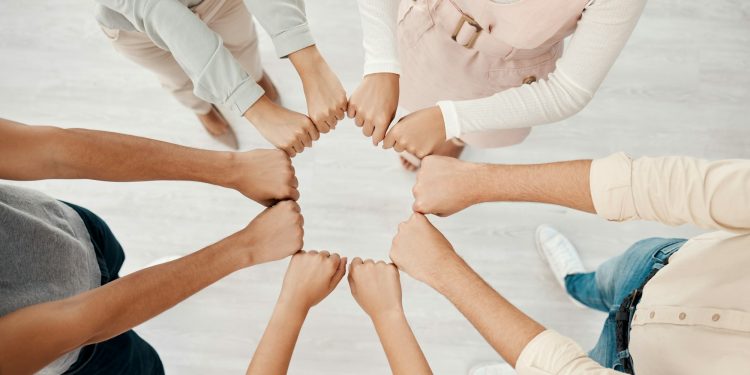 Corporate teamwork, fist bump hands of people in company diversity together and global business con